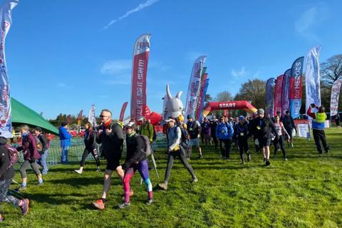 Picture of people walking with flags in the background